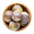 Ripe tomatillo Mexican husk tomato, Physalis philadelphica, Vegetable physalis in wooden bowl isolated on white. Top view