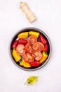 Ripe Tomato and Peppers Ready to Bake Vegetables on Black Plate Vertical Royalty Free Stock Photo