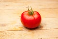 Ripe tomato on wooden background