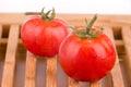 Ripe tomato on wooden grid