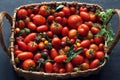 ripe tomatoes of different varieties and colors, vegetables in a basket.