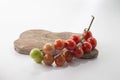 Ripe tomatoes on lie on a cutting board on a white background,, Royalty Free Stock Photo