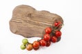 Ripe tomatoes on lie on a cutting board on a white background,, Royalty Free Stock Photo