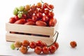 Ripe tomatoes on lie in a wooden box on a white background,, Royalty Free Stock Photo