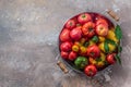 Ripe tomatoes in a pan on stone background, copy space Royalty Free Stock Photo