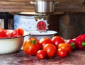 Ripe tomatoes, red sweet peppers and a handmade vintage meat grinder on the table Royalty Free Stock Photo