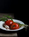 Ripe tomatoes and scallions on old wooden table