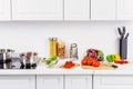 ripe vegetables on cutting boards pans on electric stove