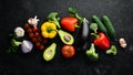 Ripe vegetables. Fresh vegetables on black stone background. Tropical fruits. Top view. Royalty Free Stock Photo