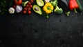 Ripe vegetables. Fresh vegetables on black stone background. Tropical fruits. Top view. Royalty Free Stock Photo