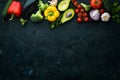 Ripe vegetables. Fresh vegetables on black stone background. Tropical fruits. Top view. Royalty Free Stock Photo