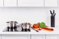 ripe vegetables on kitchen counter pans on electric stove