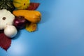 Ripe vegetables and yellow, autumn leaves on a blue background Royalty Free Stock Photo