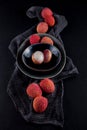 Ripe, vermilion exotic lichees decorated on a slate plate kitchen table background with napkin