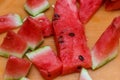 Ripe watermelon cut into pieces on an orange plate