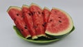 Ripe watermelon is red inside, with few seeds, cut and served on a green plate, ready to be served Royalty Free Stock Photo