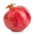 Ripe whole pomegranate close-up isolated on a white background.