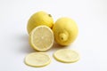 Ripe whole yellow lemon citrus fruit with lemon slice isolated on white background with clipping path. Royalty Free Stock Photo