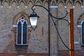 Iron vintage street lamp. In the background is an old house. Royalty Free Stock Photo