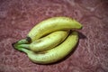 ripe yellow banana on table, dirty spots stuck to it