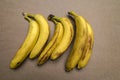 ripe yellow banana on table, dirty spots stuck to it