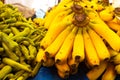 Ripe yellow bananas and green chili peppers on farmer market. Fruits and vegetables on the market counter. Healthy organic food. Royalty Free Stock Photo