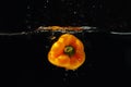 Ripe yellow bellpepper falling into the water with splash Royalty Free Stock Photo