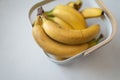 Ripe yellow fruit bananas in decorative bag. White background. Top view. Tropical sweet food