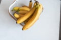 Ripe yellow fruit bananas in decorative bag. White background. Top view. Tropical sweet food