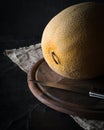 Ripe yellow melon on a dark background. Low key. Royalty Free Stock Photo