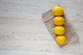 Ripe Yellow Organic Lemons on a white wooden surface, overhead view. Flat lay, top view, from above. Copy space Royalty Free Stock Photo