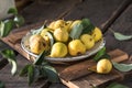 Ripe yellow pears in a plate on wooden background Royalty Free Stock Photo