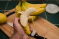 Peeled banana in a man`s hand Royalty Free Stock Photo