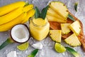 Ripe Yellow Pineapple, coconut, Smoothie with slices of Lime and ice. concept healthy food. Royalty Free Stock Photo