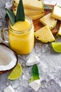 Ripe Yellow Pineapple, coconut, Smoothie with slices of Lime and ice. concept healthy food. Royalty Free Stock Photo