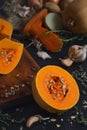 Ripe yellow pumpkin cut in half to make seasonal cream soup. Close-up, selective focus on the pumpkin. Ingredients, vegetables and Royalty Free Stock Photo