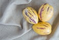 3 ripe pepino melons on a beige cloth Royalty Free Stock Photo