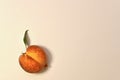 Peach on a light background with a leaf. Royalty Free Stock Photo