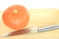 Riped orange pumpkin and silver kitchen knife