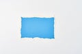 Ripped blue paper torn edge sheet on a white background. Template with piece of color paper