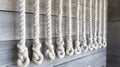Ripped cotton ropes hanging neatly on a wooden wall in