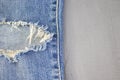 Ripped destroyed in wash blue denim jeans. isolated background Royalty Free Stock Photo