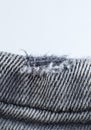 Ripped Grey hipster jeans material. Destroyed denim Gray Cloth texture. Close up Royalty Free Stock Photo