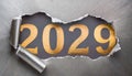 Ripped metallic paper revealling the year 2029 written in golden numbers on a gray background