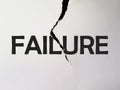 A ripped off paper showing the word FAILURE in black