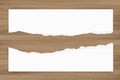 Ripped paper background on brown wood texture. Torn paper edge. Royalty Free Stock Photo