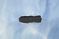 Ripped paper of blue sky on black background Royalty Free Stock Photo