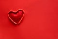 Ripped paper hole heart shaped with felt heart on red paper background. Valentine`s day celebration concept Royalty Free Stock Photo