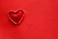 Ripped paper hole heart shaped with felt heart on red paper background. Valentine`s day celebration concept Royalty Free Stock Photo