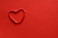 Ripped paper hole heart shaped on red paper background. Valentine`s day celebration concept Royalty Free Stock Photo